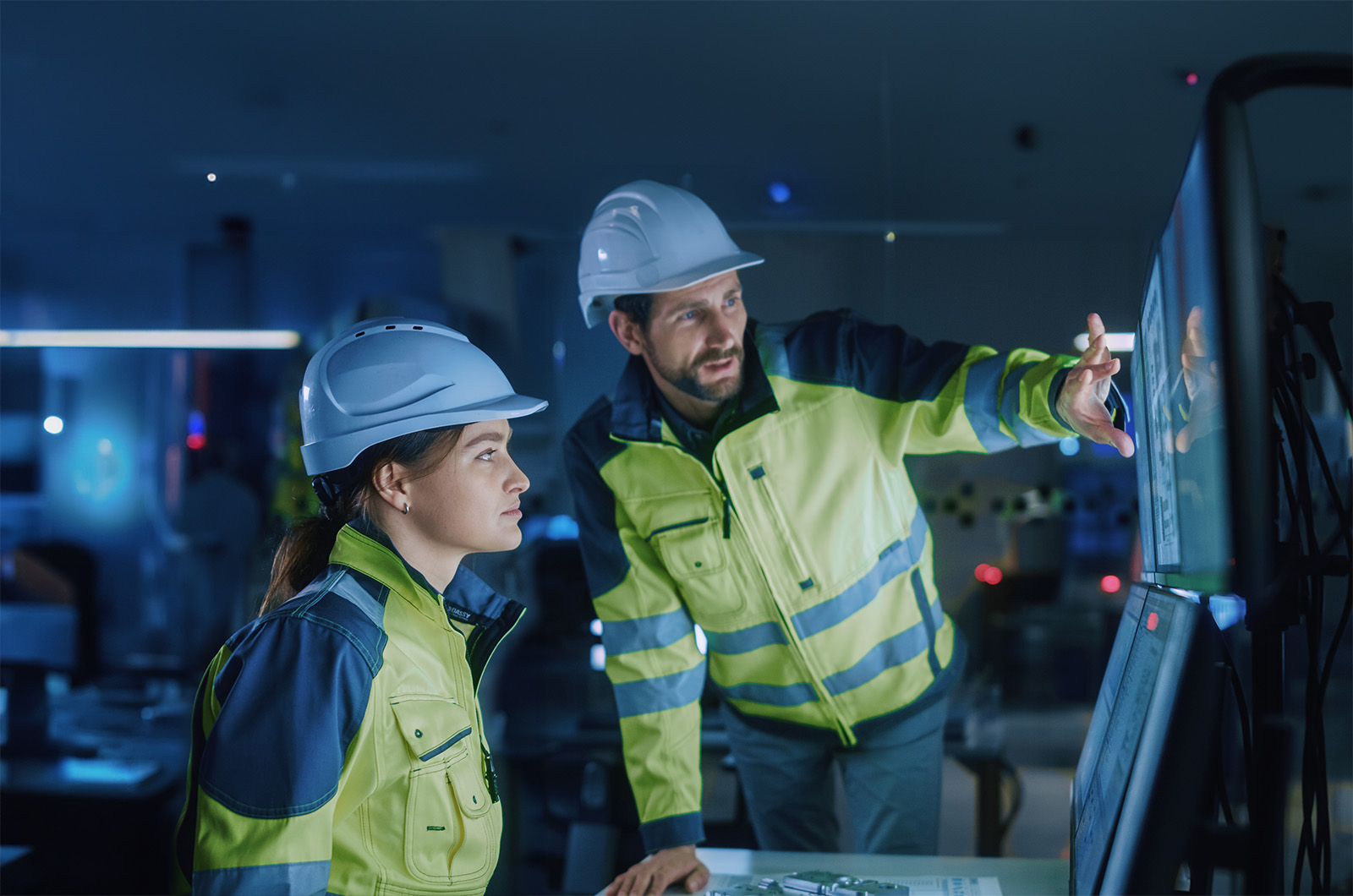 two workers looking at a computer screen
